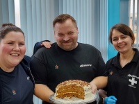 Staff at Gripple holsing a carrot cake